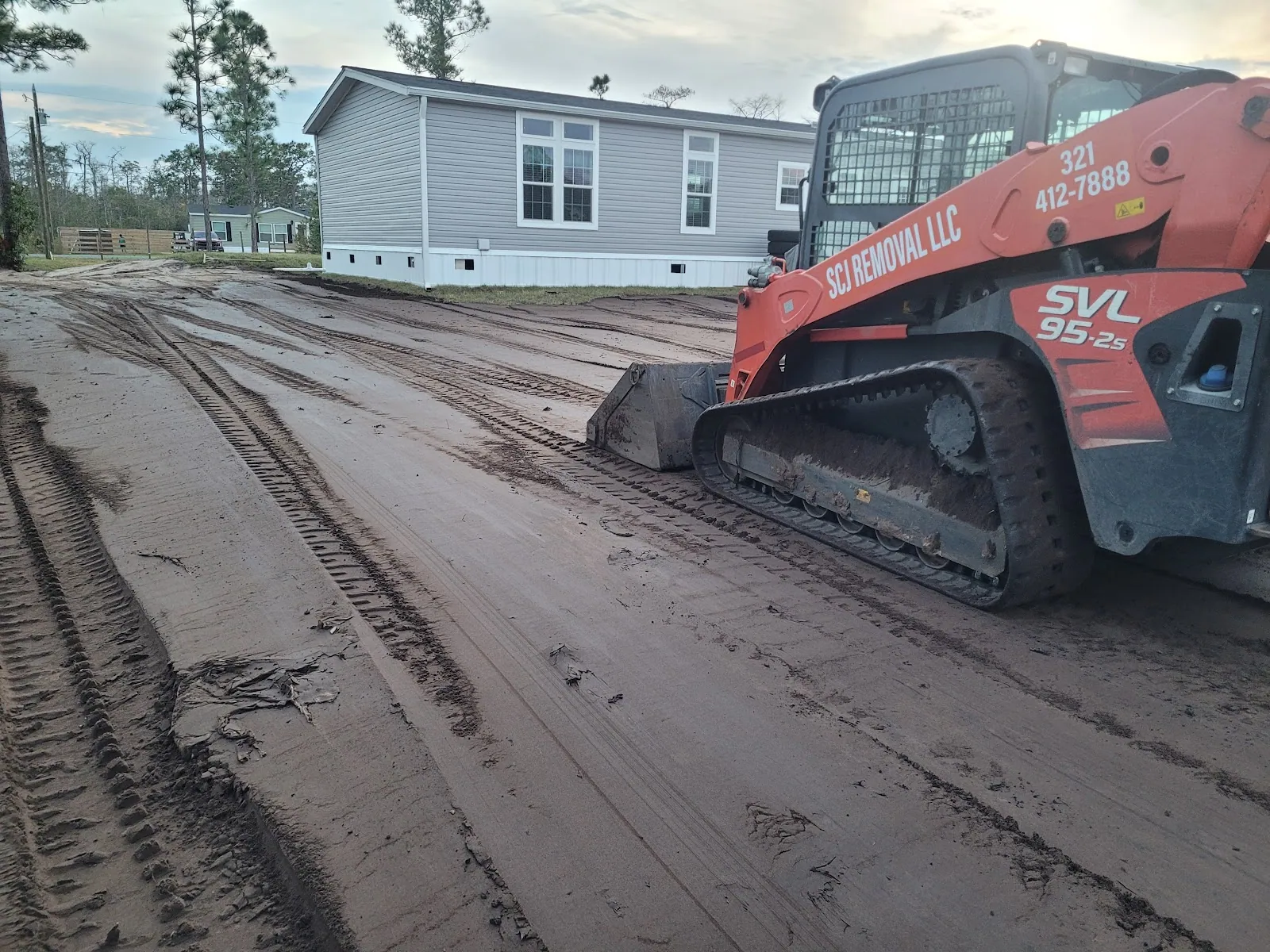 SCJ Removal track loader shaping a new driveway in St. Cloud, FL